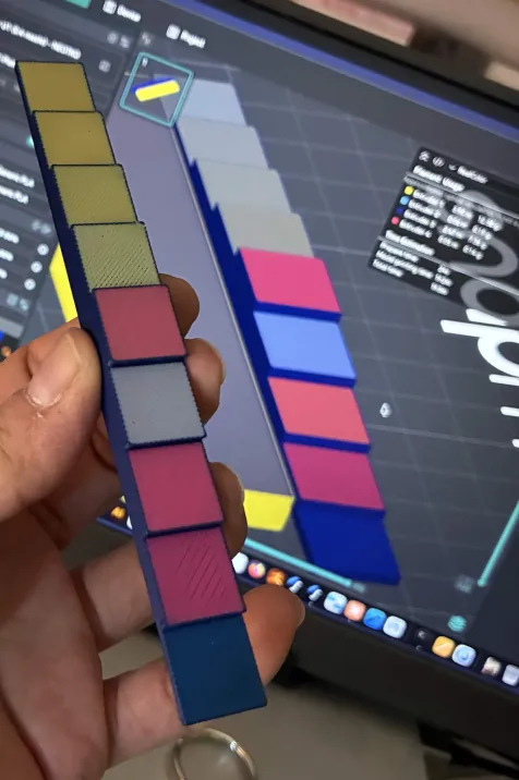 A printed part held next to the RealColor preview of the same G-code on screen